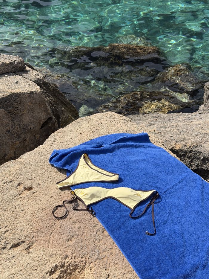 Beach flat lay with towel and bikini